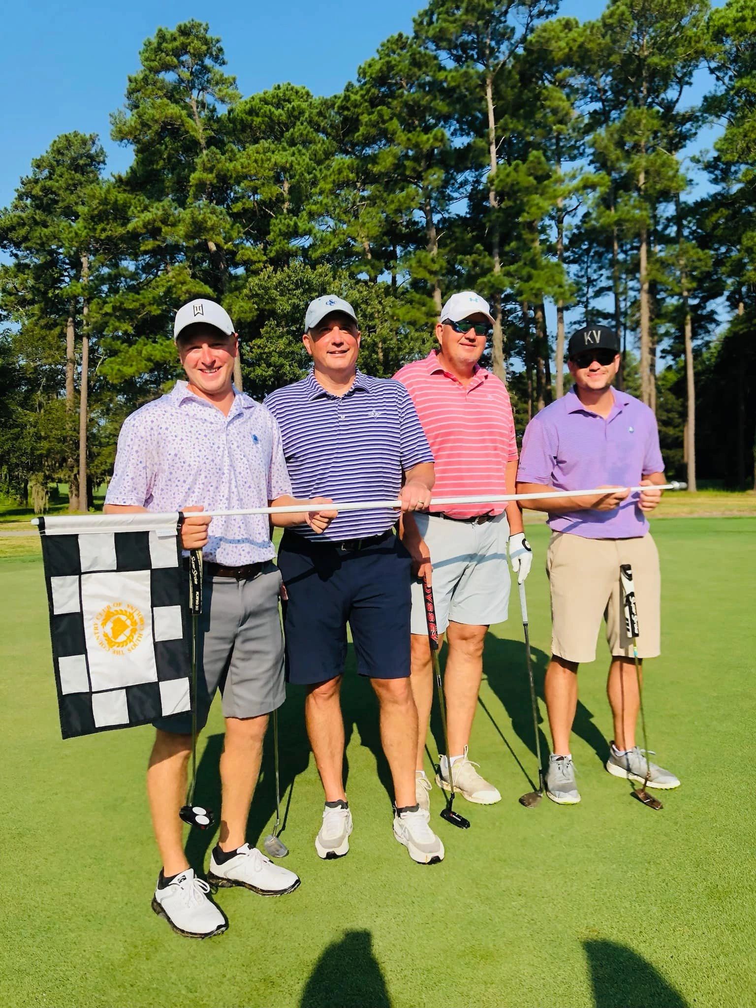 Golfers posing on putting green
