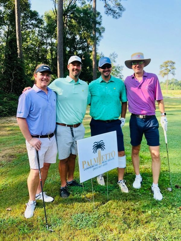 Foursome with Palmetto Commercial Real Estate sign