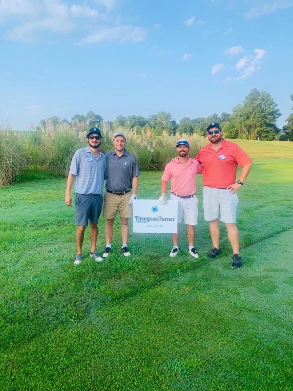 Foursome with Thompson Turner sign